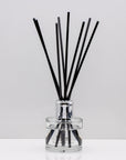 Warm, woody essence of sandalwood with the deep, resinous notes of myrrh Luxury long lasting Sandalwood Myrrh reed diffuser with natural black sticks in a 100ml clear glass bottle with silver top