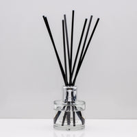 Warm, woody essence of sandalwood with the deep, resinous notes of myrrh Luxury long lasting Sandalwood Myrrh reed diffuser with natural black sticks in a 100ml clear glass bottle with silver top