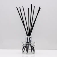 Relax with the scent of clean freshly washed towels of Luxury long lasting Soft Sheets reed diffuser with natural black sticks in a 100ml clear glass bottle with silver top