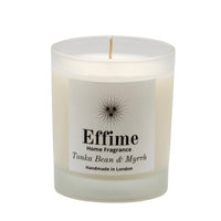 "Scented candle: frosted white glass jar with white label reading 'Effime Home Fragrance Tonka Bean & Myrrh'.
Luxury fruity and Woody home fragrance"