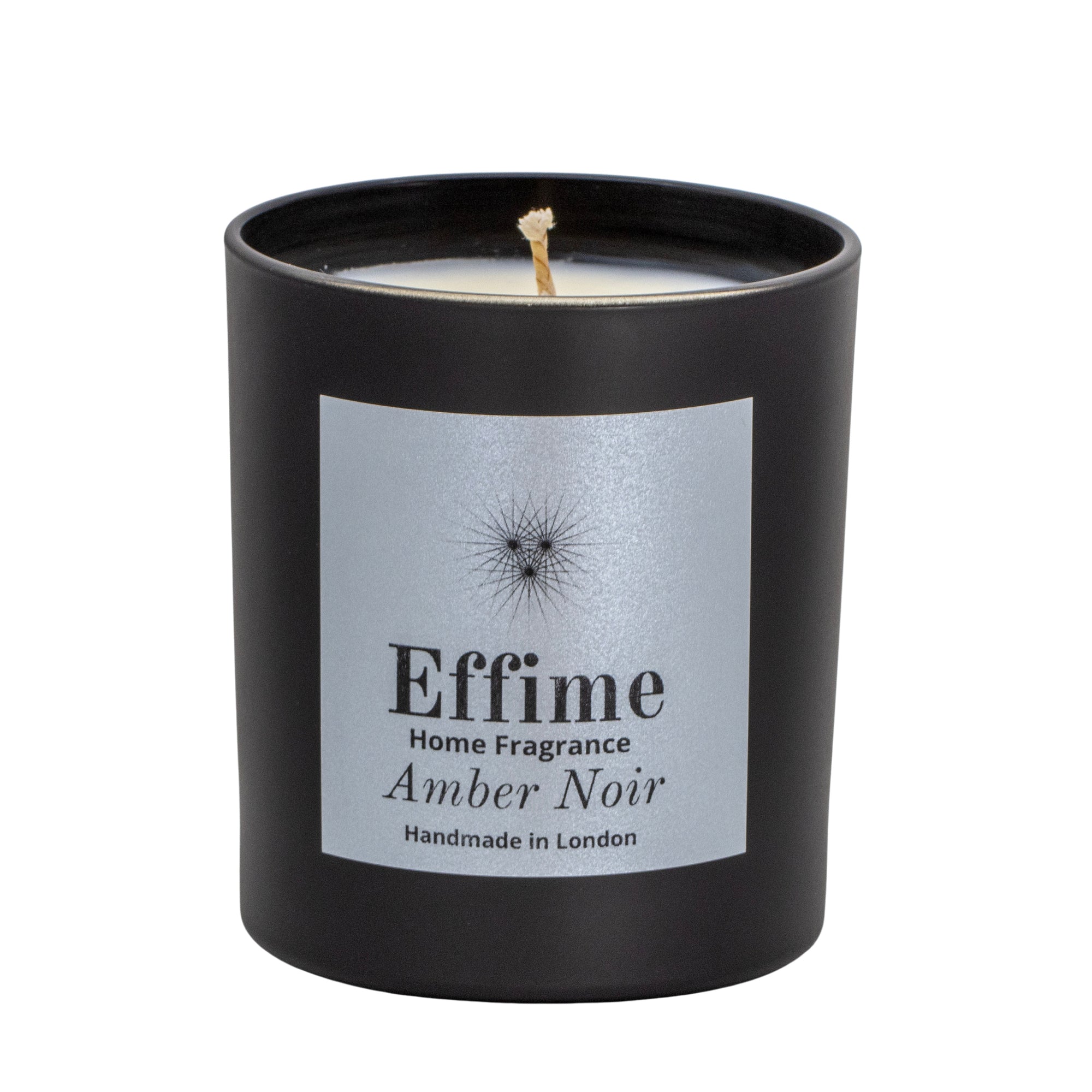 "Scented candle: Black glass jar with silver label reading 'Effime Home Fragrance Amber Noir'. 
Luxury Spicy and Woody home fragrance"