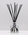 Snuggle up on a cold winter's night and indulge your senses with opulent aromas of rich Luxury long lasting Black Pomegranate reed diffuser with natural black sticks in a 100ml clear glass bottle with silver top