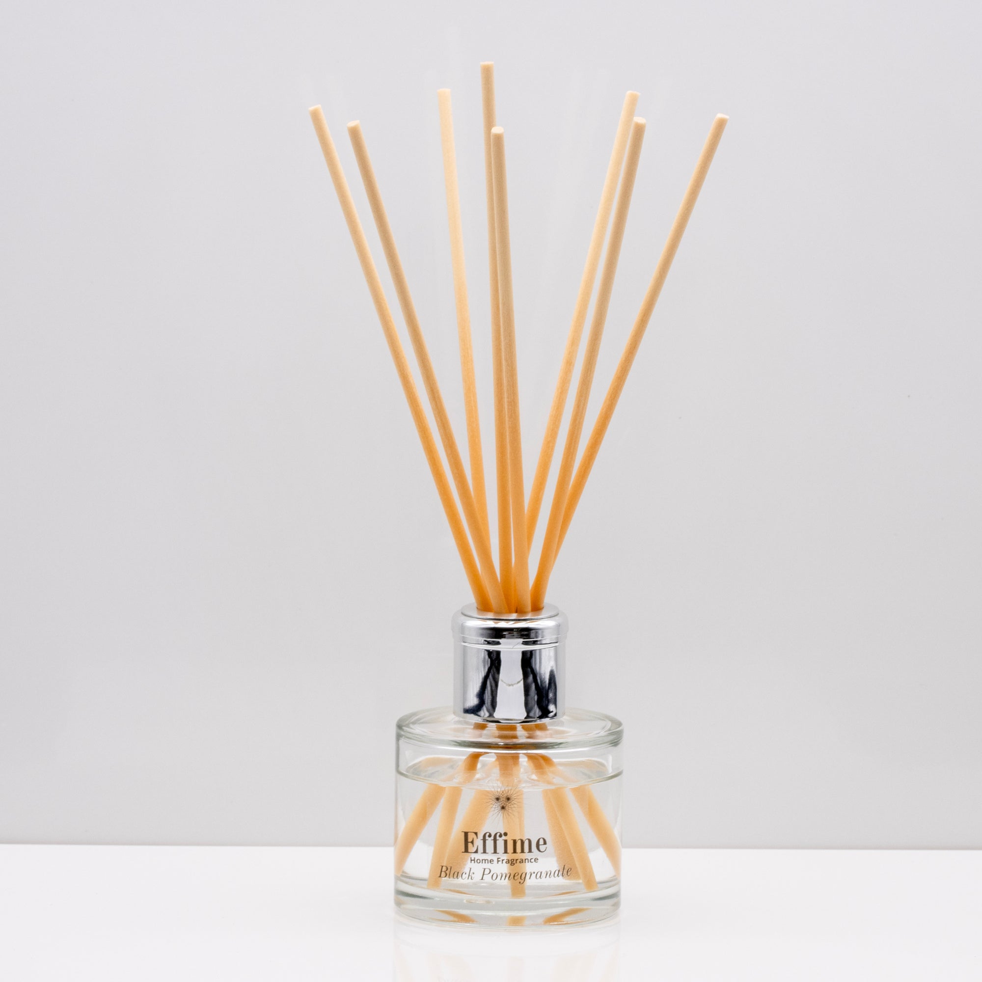 Snuggle up on a cold winter's night and indulge your senses with opulent aromas of rich Luxury long lasting Black Pomegranate reed diffuser with natural wooden sticks in a 100ml clear glass bottle with silver top