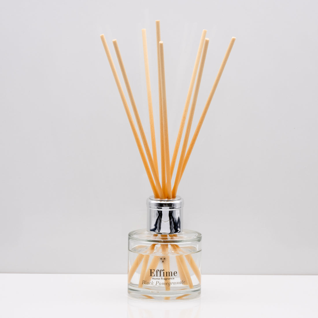 Snuggle up on a cold winter's night and indulge your senses with opulent aromas of rich Luxury long lasting Black Pomegranate reed diffuser with natural wooden sticks in a 100ml clear glass bottle with silver top