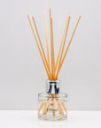 Snuggle up on a cold winter's night and indulge your senses with opulent aromas of rich Luxury long lasting Black Pomegranate reed diffuser with natural wooden sticks in a 100ml clear glass bottle with silver top