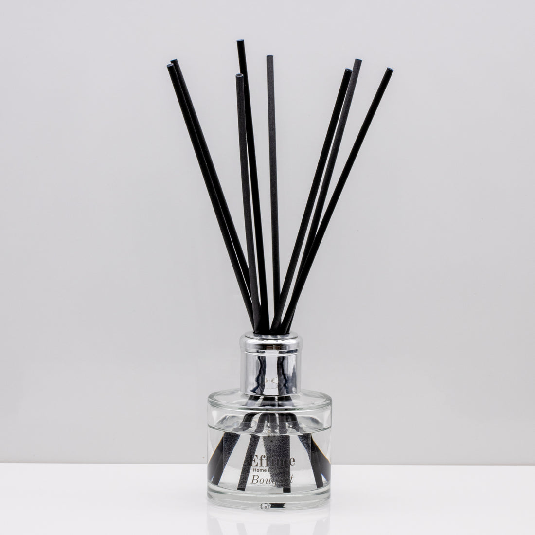 Crisp uplifting aromas of wild meadow flowers and morning dew, nestled on a bed of sweet amber Luxury long lasting Bouquet reed diffuser with natural black sticks in a 100ml clear glass bottle with silver top.