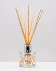Crisp uplifting aromas of wild meadow flowers and morning dew, nestled on a bed of sweet amber Luxury long lasting Bouquet reed diffuser with natural wooden sticks in a 100ml clear glass bottle with silver top.