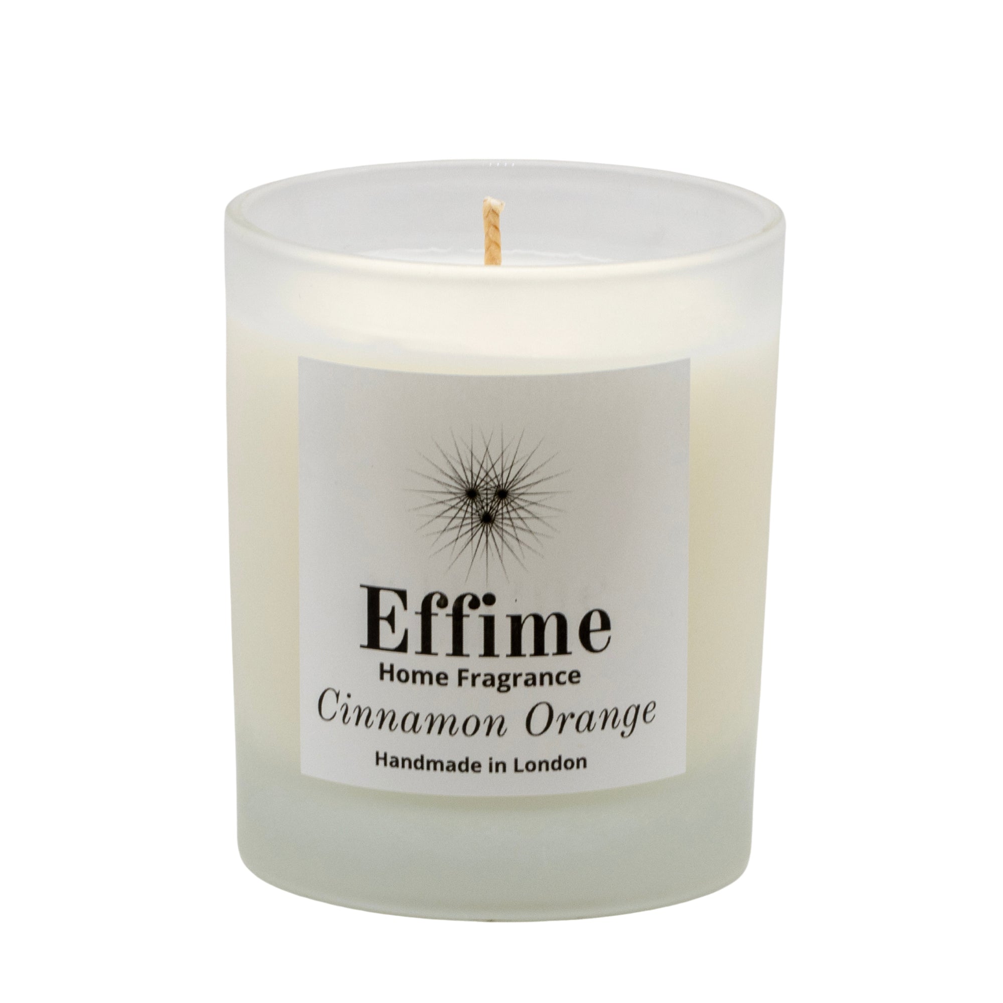 "Scented candle: frosted white  glass jar with white label reading 'Effime Home Fragrance Cinnamon Orange'. 
Luxury  Spicy, Woody, Fruity home fragrance"