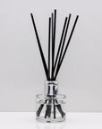 Sweet cinnamon, fresh orange, and woody clove lending itself to spicy and yet citrus aroma Luxury long lasting cosy reed diffuser with natural black sticks in a 100ml clear glass bottle with silver top.