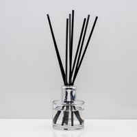 Sweet cinnamon, fresh orange, and woody clove lending itself to spicy and yet citrus aroma Luxury long lasting cosy reed diffuser with natural black sticks in a 100ml clear glass bottle with silver top.