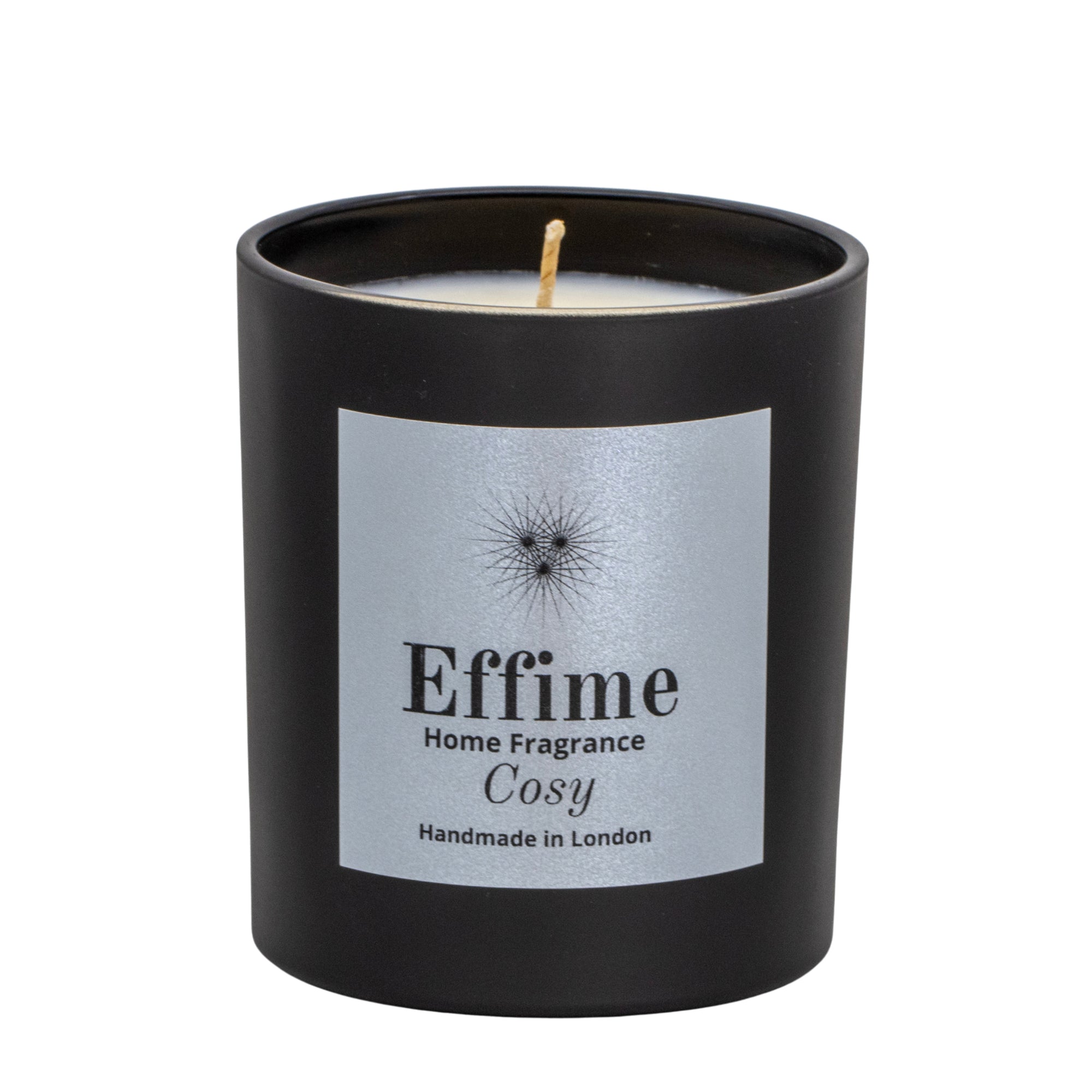 "Scented candle: Black glass jar with silver label reading 'Effime Home Fragrance Cosy'. 
Luxury  Spicy, Woody, Fruity home fragrance"
