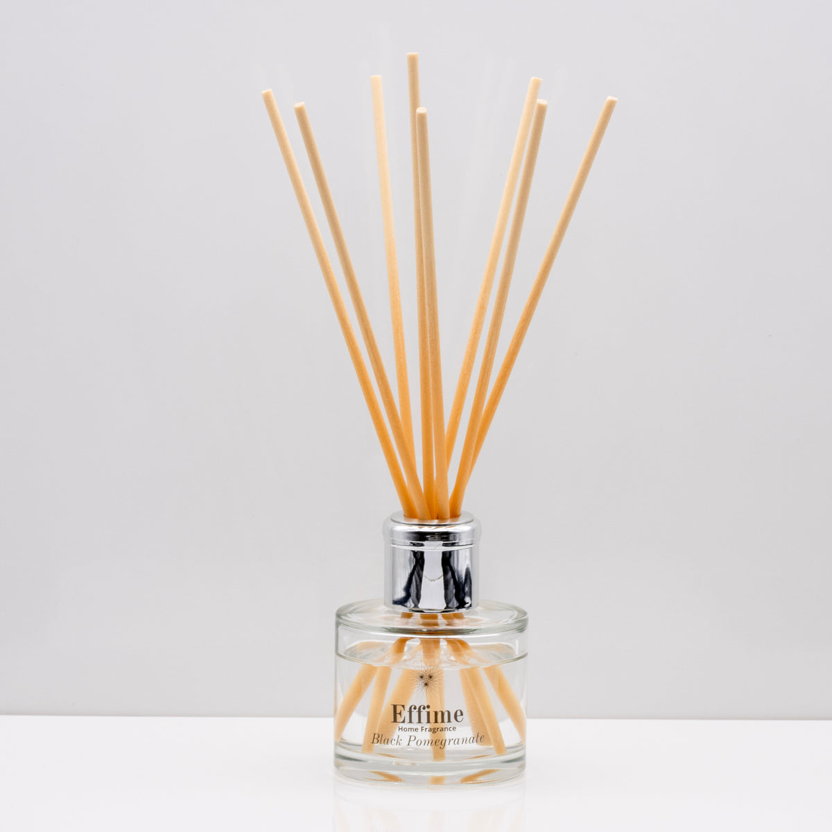Snuggle up on a cold winter's night and indulge your senses with opulent aromas of rich Luxury long lasting Black Pomegranate reed diffuser with natural wooden sticks in a 100ml clear glass bottle with silver top