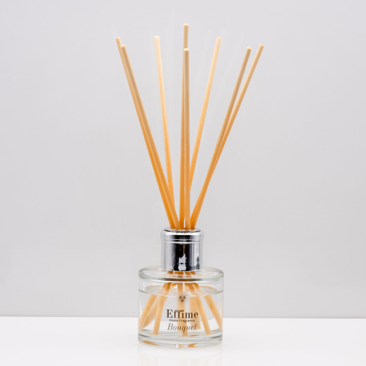 Crisp uplifting aromas of wild meadow flowers and morning dew, nestled on a bed of sweet amber Luxury long lasting Bouquet reed diffuser with natural wooden sticks in a 100ml clear glass bottle with silver top.