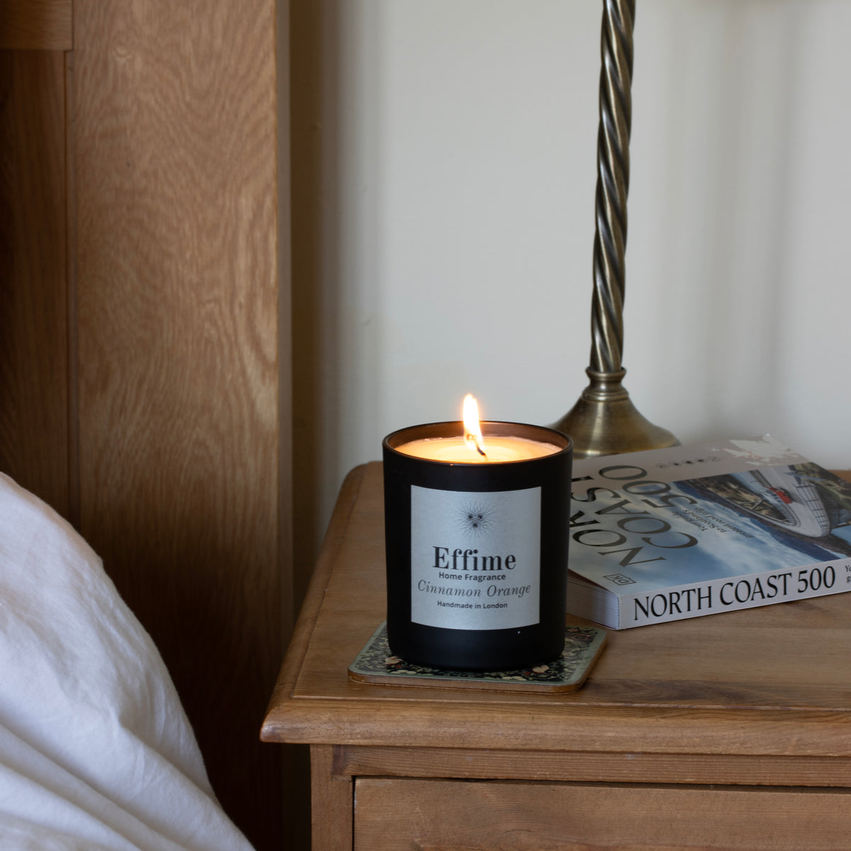 Effime Home Cinnamon Orange scented soy candle in a matt black glass jar