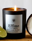 Effime Home Coconut Lime scented soy candle in a matt black glass jar with freshly cut limes and coconut