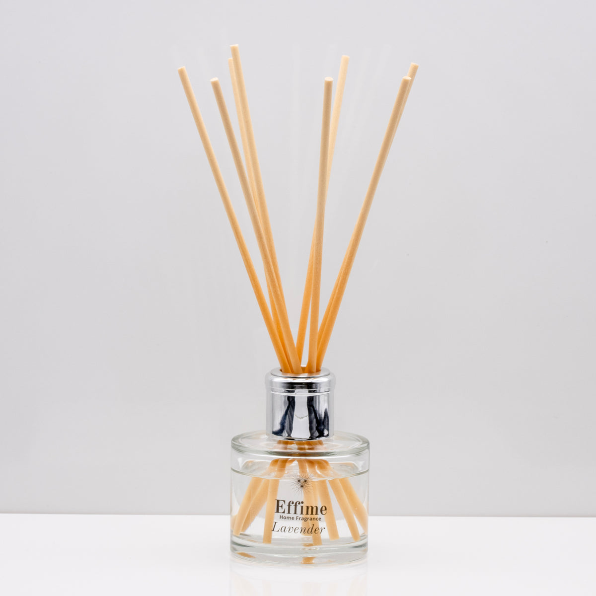 Relax in the exquisitely encapsulated, fresh aromatic herbal notes of Luxury long lasting lavender reed diffuser with natural wooden sticks in a 100ml clear glass bottle with silver top