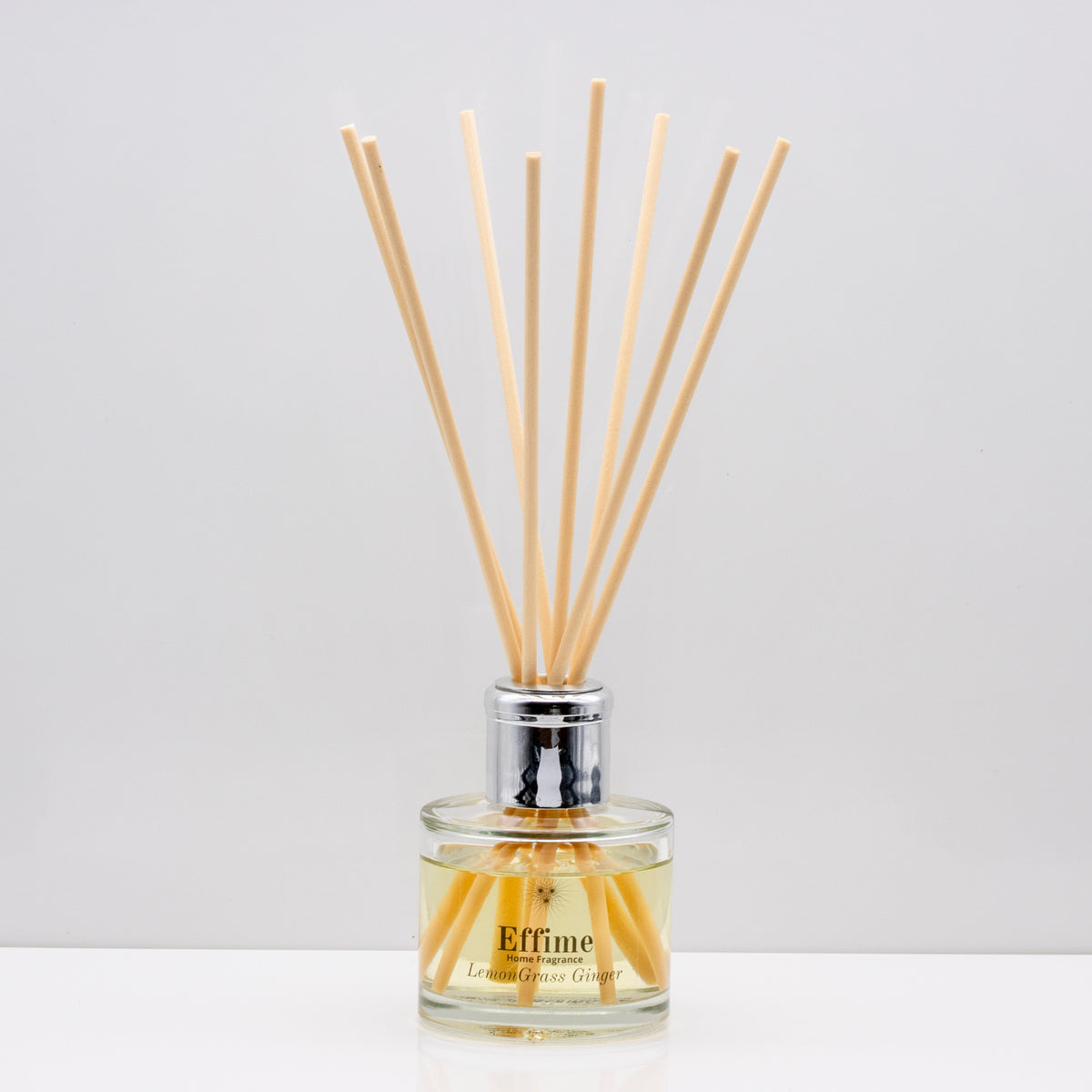 Citrus notes and warm freshly sliced ginger Luxury long lasting Lemongrass Ginger reed diffuser with natural wooden sticks in a 100ml clear glass bottle with silver top
