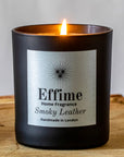 Effime Home Smoky Leather scented soy lit candle in a matt black glass jar.