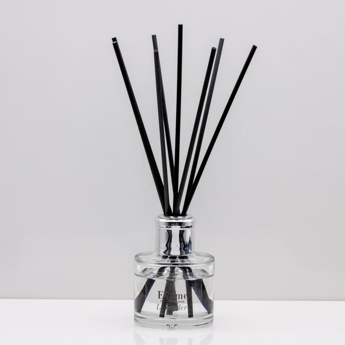 Relax in the exquisitely encapsulated, fresh aromatic herbal notes of Luxury long lasting lavender reed diffuser with natural black sticks in a 100ml clear glass bottle with silver top