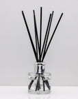 Relax in the exquisitely encapsulated, fresh aromatic herbal notes of Luxury long lasting lavender reed diffuser with natural black sticks in a 100ml clear glass bottle with silver top