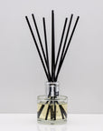 Citrus notes and warm freshly sliced ginger Luxury long lasting Lemongrass Ginger reed diffuser with natural black sticks in a 100ml clear glass bottle with silver top