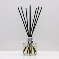 Citrus notes and warm freshly sliced ginger Luxury long lasting Lemongrass Ginger reed diffuser with natural black sticks in a 100ml clear glass bottle with silver top
