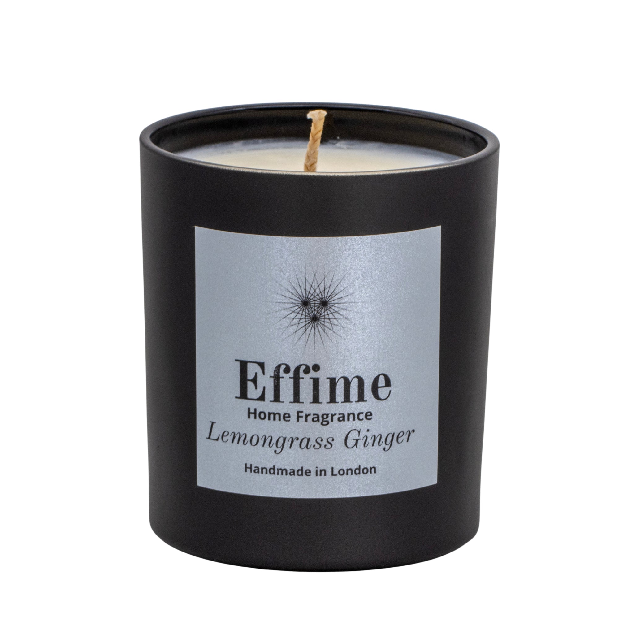 "Scented candle: Black glass jar with silver label reading 'Effime Home Fragrance Lemongrass Ginger'. 
Luxury  Fresh home fragrance"