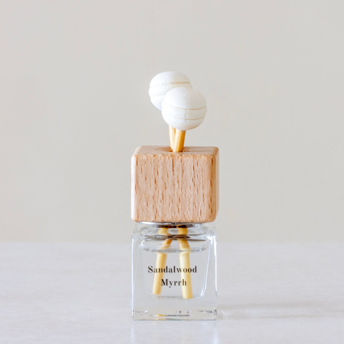 Warm, woody essence of sandalwood with the deep, resinous notes of myrrh Luxury long lasting Sandalwood Myrrh Car diffuser with natural wooden sticks in a clear glass bottle with wooden top