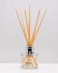 warm, woody essence of sandalwood with the deep, resinous notes of myrrh Luxury long lasting Sandalwood Myrrh reed diffuser with natural wooden sticks in a 100ml clear glass bottle with silver top
