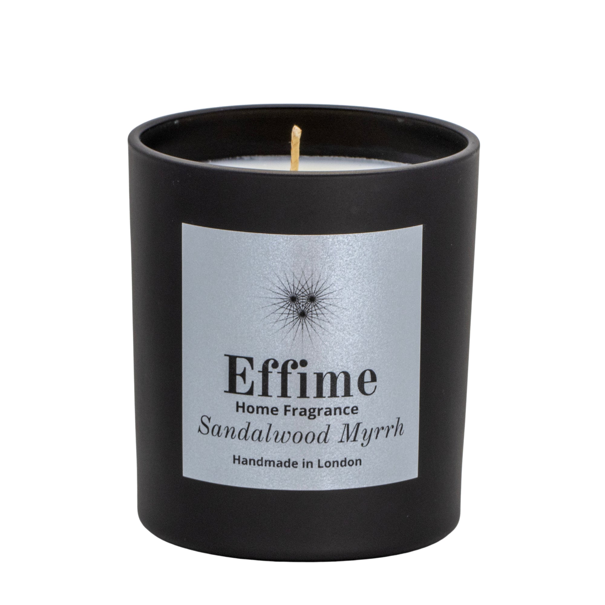 "Scented candle: Black glass jar with silver label reading 'Effime Home Fragrance Sandalwood Myrrh'. 
Luxury Spicy and Woody home fragrance"