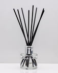 Relax with the scent of clean freshly washed towels of Luxury long lasting Soft Sheets reed diffuser with natural black sticks in a 100ml clear glass bottle with silver top