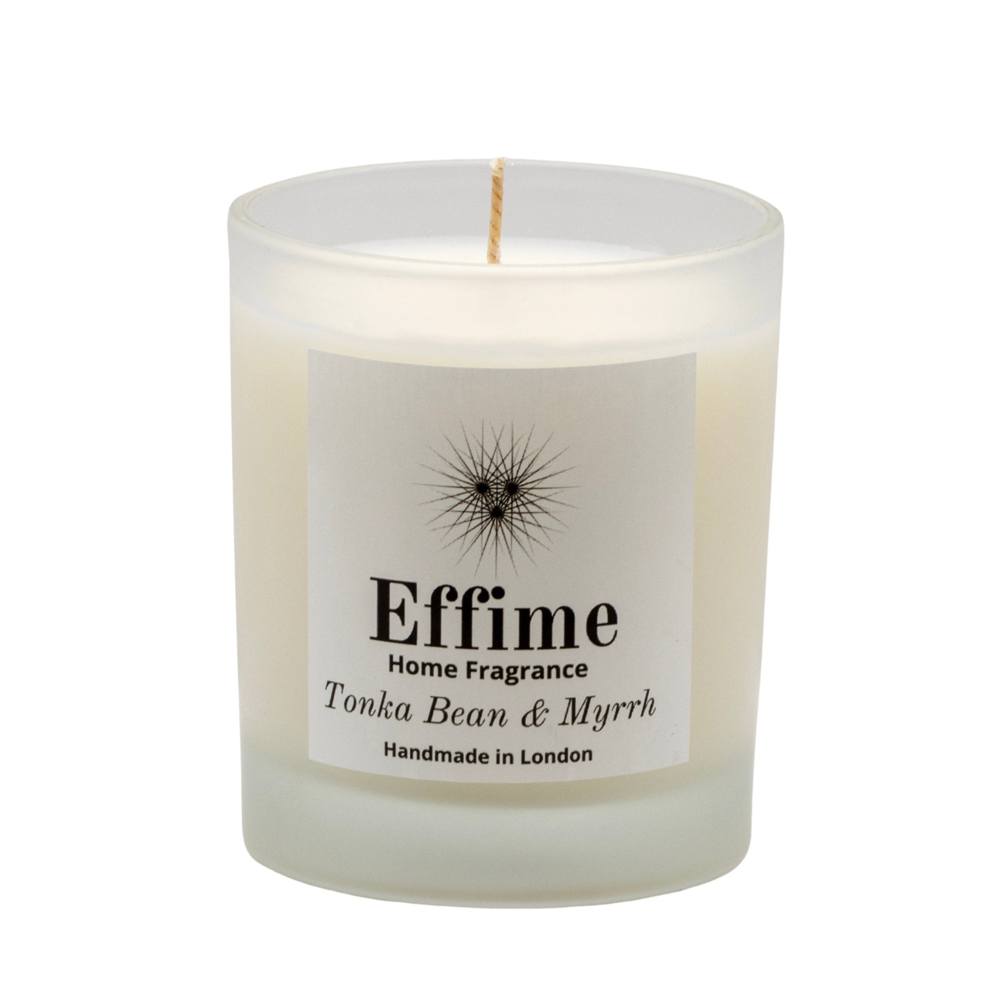 "Scented candle: frosted white  glass jar with white label reading 'Effime Home Fragrance  Tonka Bean & Myrrh'. 
Luxury fruity and Woody home fragrance"
