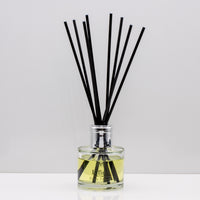 Perfect for slow evenings and quiet moments of reflection Luxury long lasting Tonka Tobacco reed diffuser with natural black sticks in a 100ml clear glass bottle with silver top.